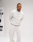 Man modeling the RUDIS Hex Relaxed Comfort Fleece Crewneck in Heather Silver, paired with matching fleece pants for a coordinated casual look.
 Copy alt text