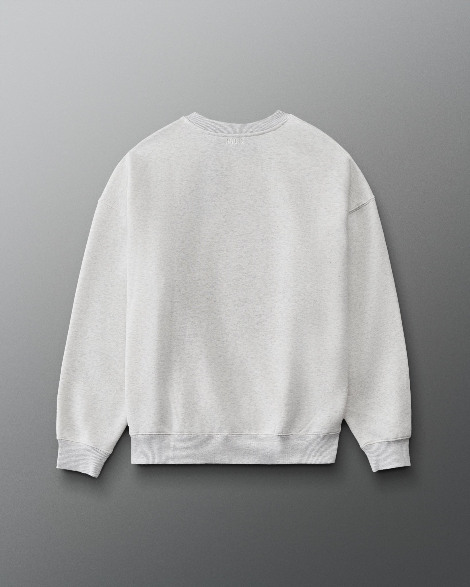 RUDIS Hex Relaxed Comfort Fleece Crewneck in Heather Silver, back view showing a clean minimalist design, subtle RUDIS branding below the collar, dropped shoulders, and ribbed cuffs and hem. Copy Alt Text
