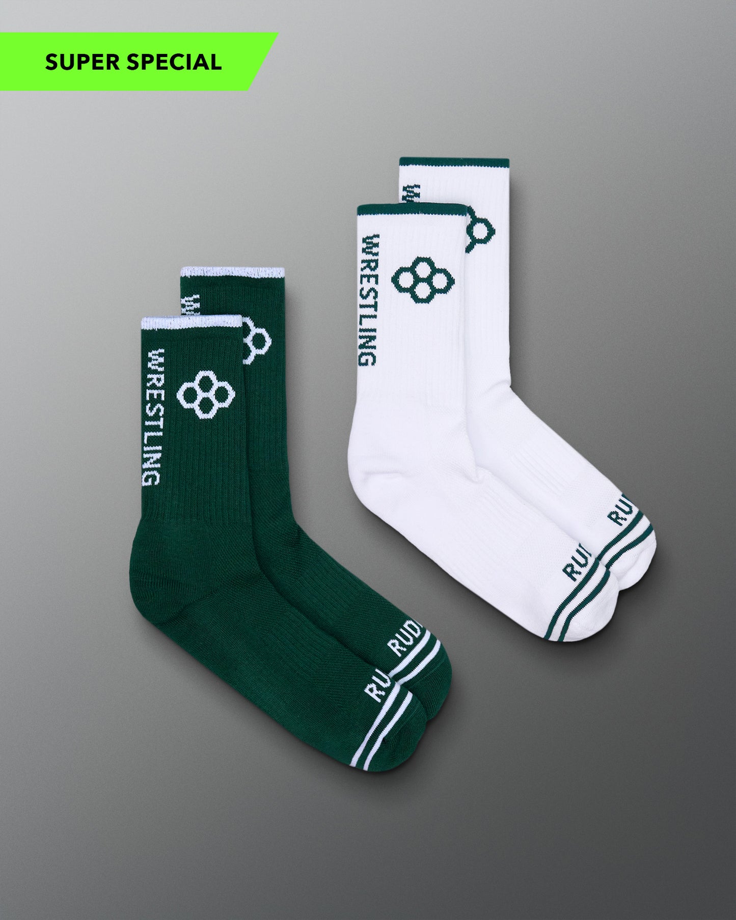 Green and white wrestling socks on a gray background
