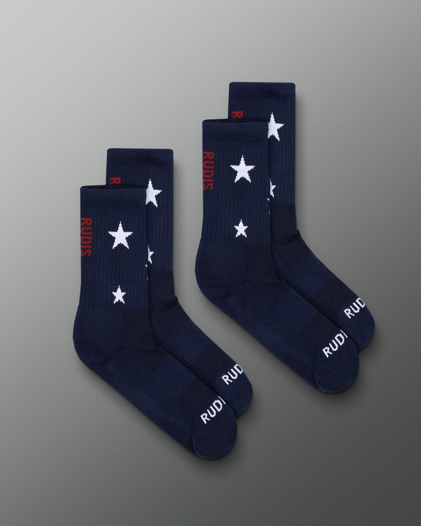 Navy socks with white star patterns and red text on a gray background