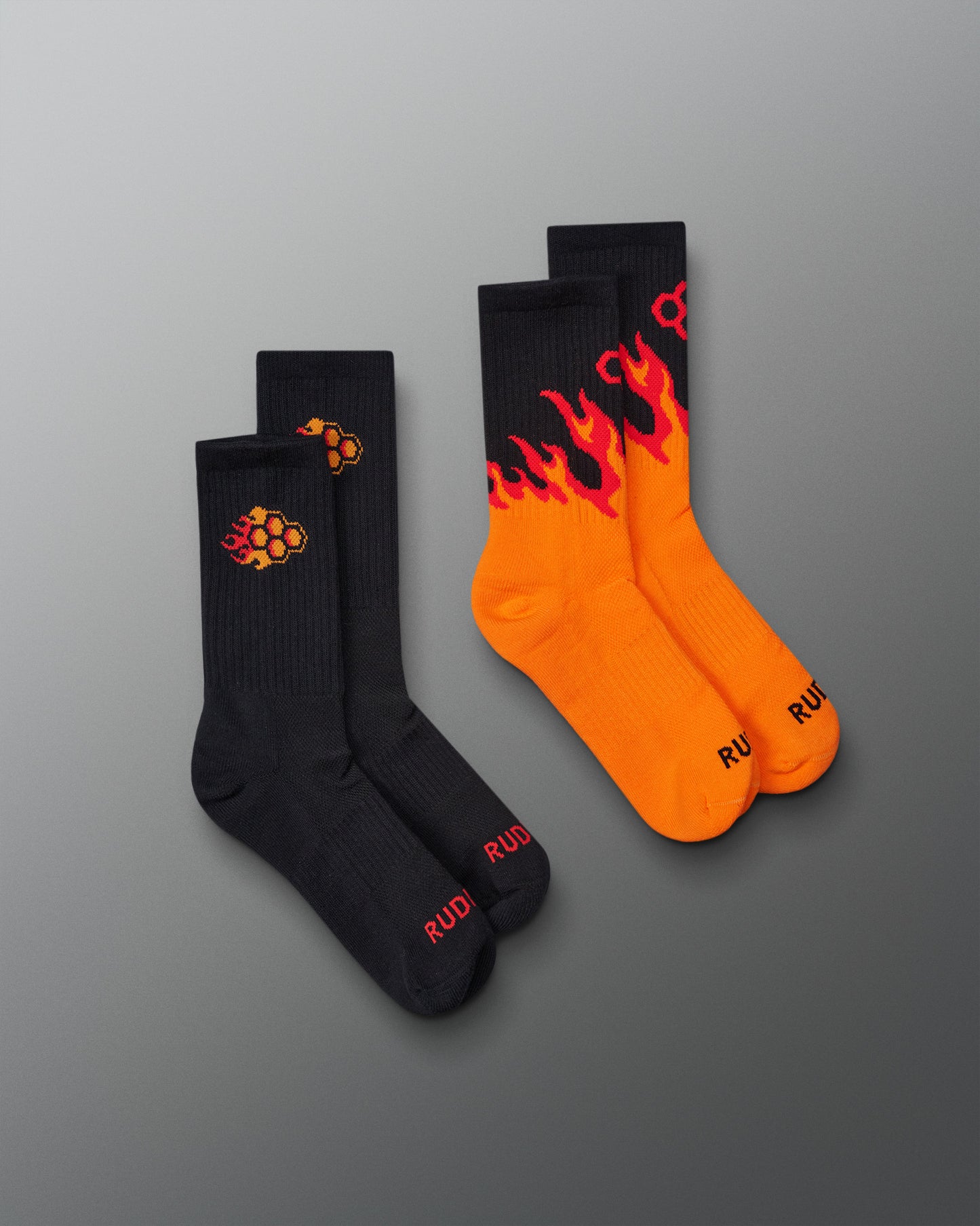 Two pairs of socks with flame design on a gray background