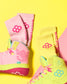 Pink and yellow wrestling shoes with matching socks on a yellow background