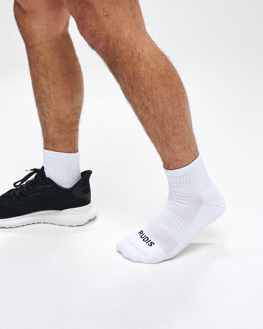 White socks with 'RUDIS' branding worn by a person on a white background