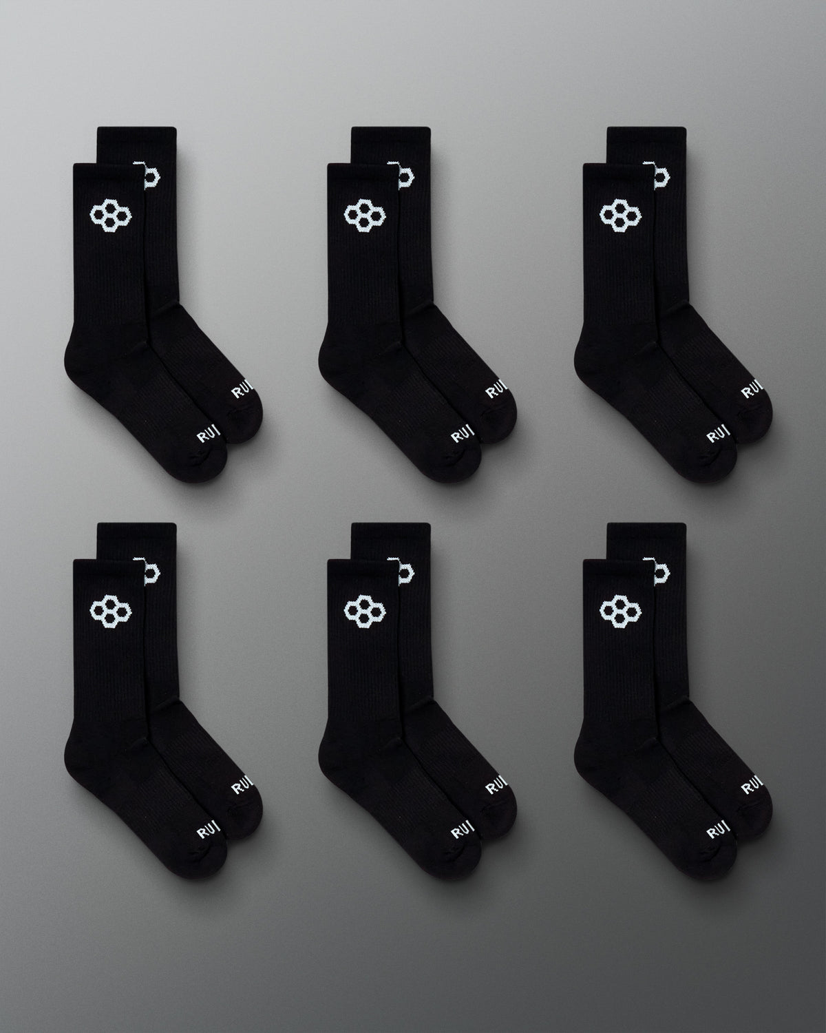 RUDIS Essential Hex Cushion Crew Socks 6-pack in black, featuring white RUDIS Hex logos at the crew and RUDIS branding at the toe.