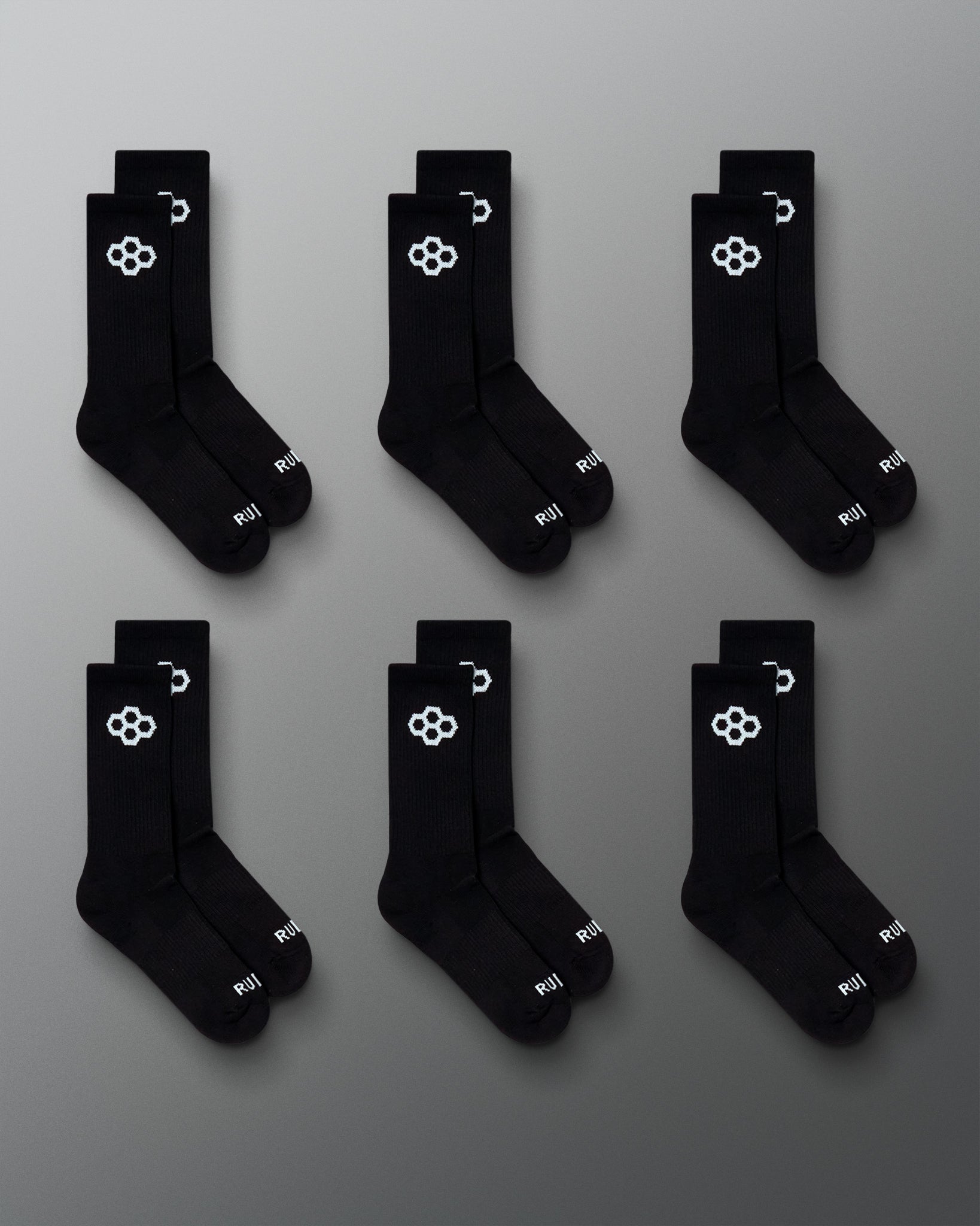 RUDIS Essential Hex Cushion Crew Socks 6-pack in black, featuring white RUDIS Hex logos at the crew and RUDIS branding at the toe.