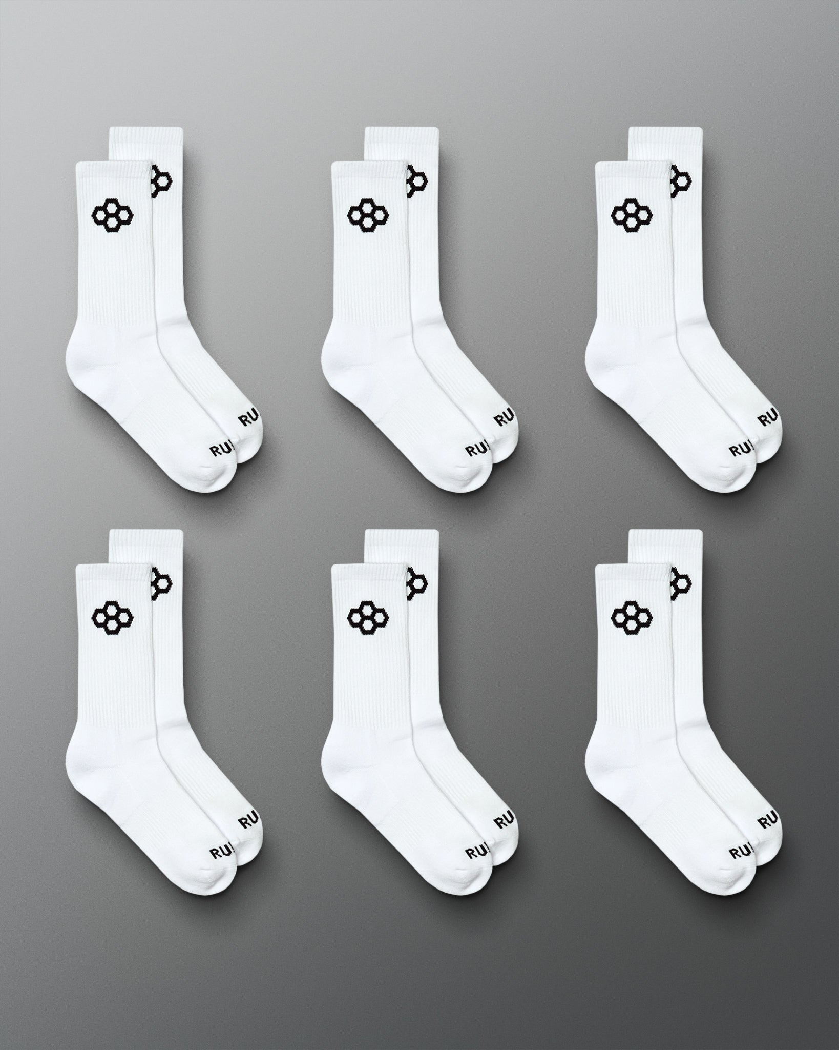RUDIS Essential Hex Cushion Crew Socks 6-pack in white, featuring black RUDIS Hex logos at the crew and RUDIS branding at the toe.