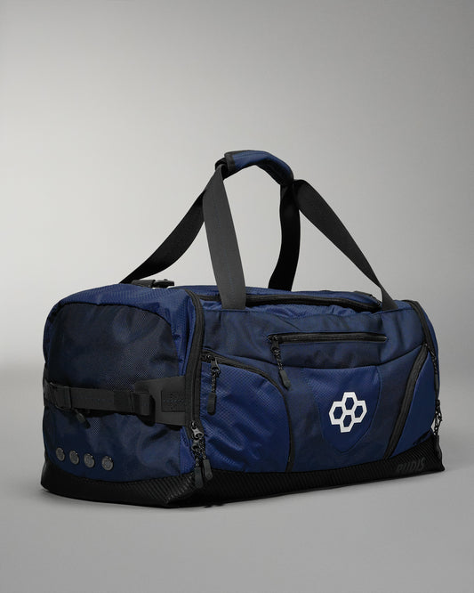 Blue wrestling duffel bag with black straps on a gray background