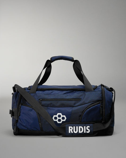 Blue wrestling duffel bag with black straps and 'RUDIS' branding on a gray background