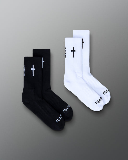 Black and white socks with cross designs on a gradient gray background
