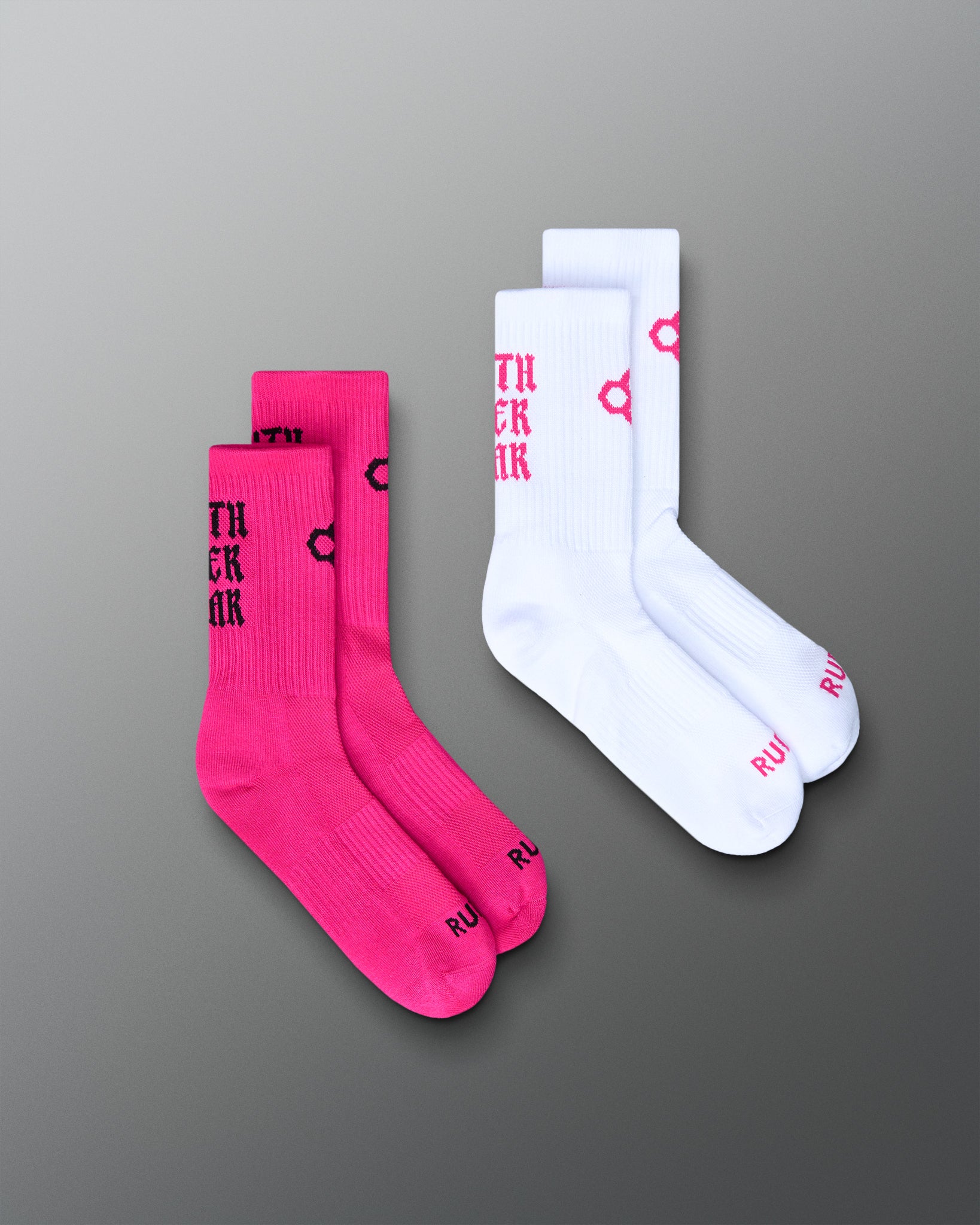 Two pairs of socks, one pink and one white, with text on a gray background.