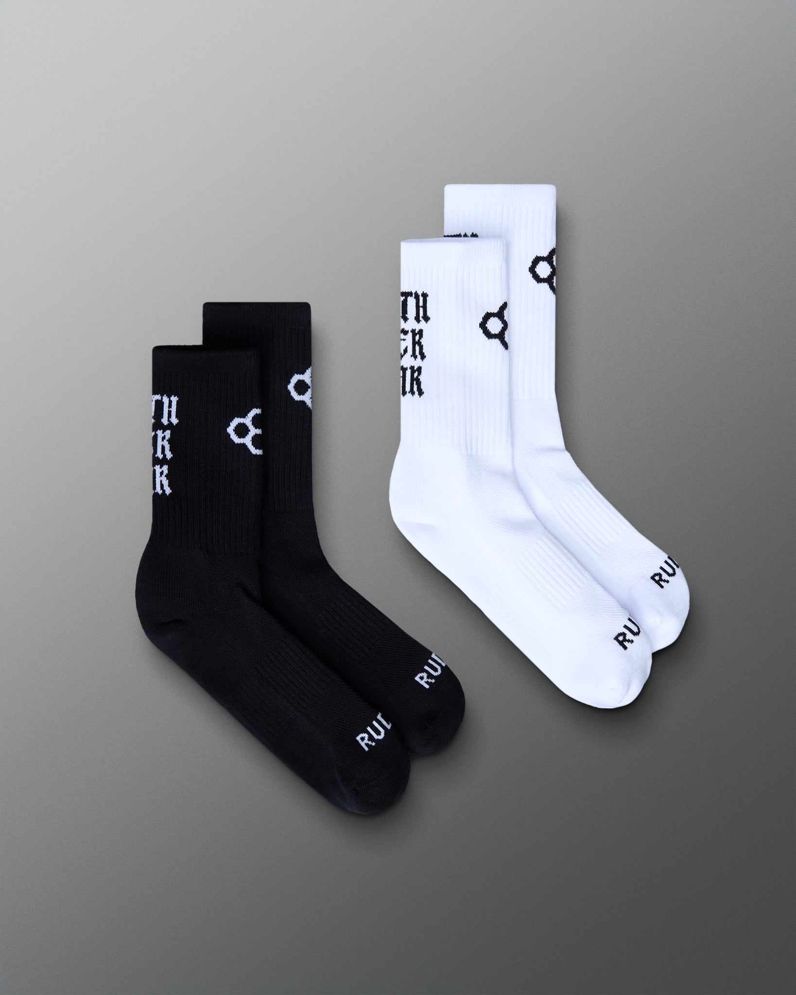 Black and white socks with branding on a gray background