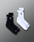 Black and white socks with branding on a gray background