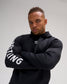 Male athlete wearing the black RUDIS Wrestling COOL-FEEL Hoodie with arms crossed, showcasing the bold white WRESTLING sleeve graphic.