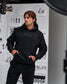 Person wearing a black hoodie with 'RUDIS' branding in a studio setting.