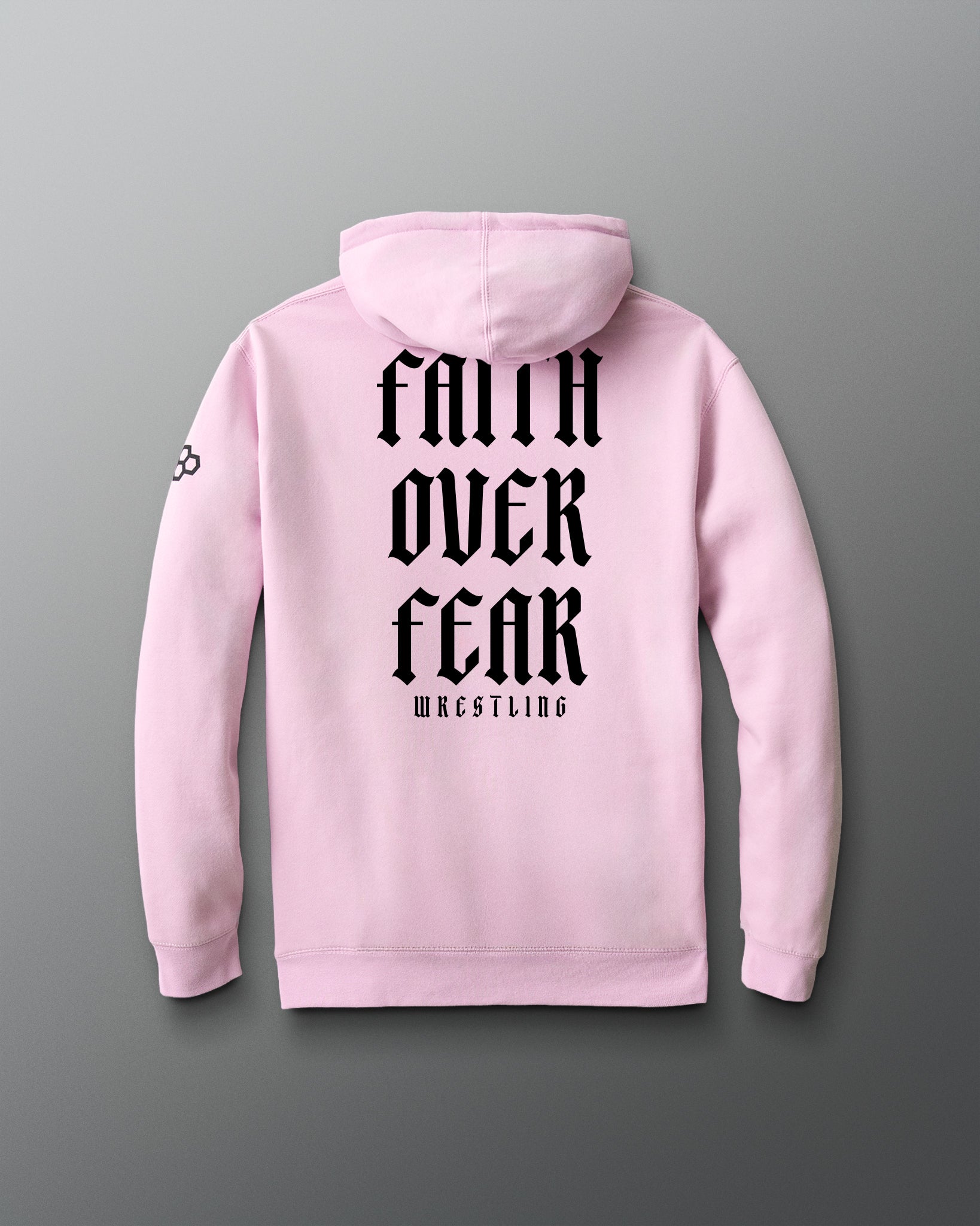Pink hoodie with 'Faith Over Fear Wrestling' text on the back against a gray background