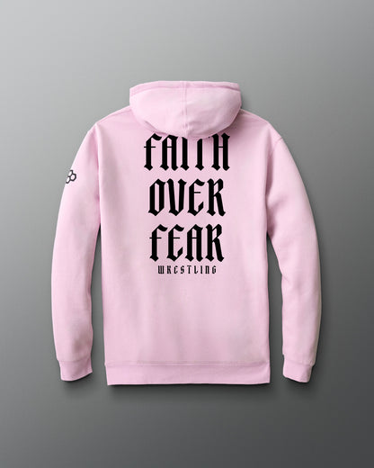 Pink hoodie with 'Faith Over Fear Wrestling' text on the back against a gray background