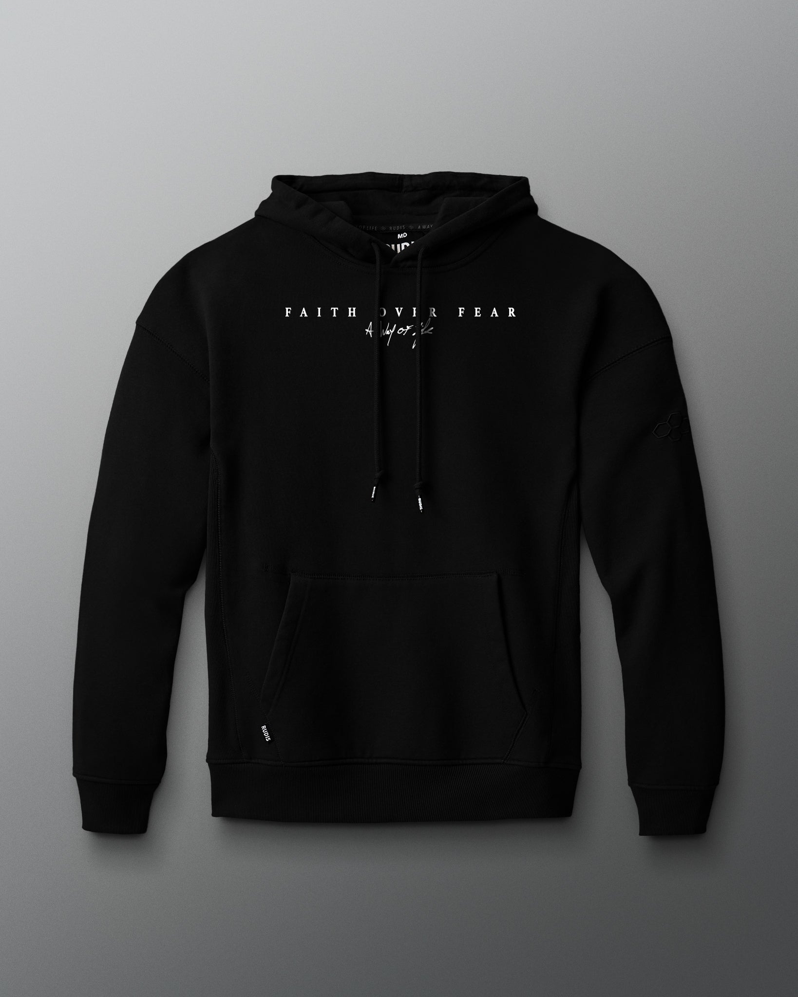 Black hoodie with front faith over fear text on a gray background