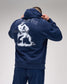 Person wearing a navy blue hoodie with a graphic design on the back against a gray background