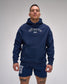 Man wearing a navy hoodie and shorts with 'RUDIS' branding on a gray background