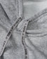 Close-up of gray fabric with 'Rudis' branding on a tag.