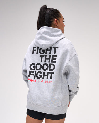 Person wearing a gray hoodie with 'Fight the Good Fight' text on the back, standing against a plain background.