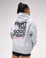Person wearing a gray hoodie with 'Fight the Good Fight' text on the back, standing against a plain background.