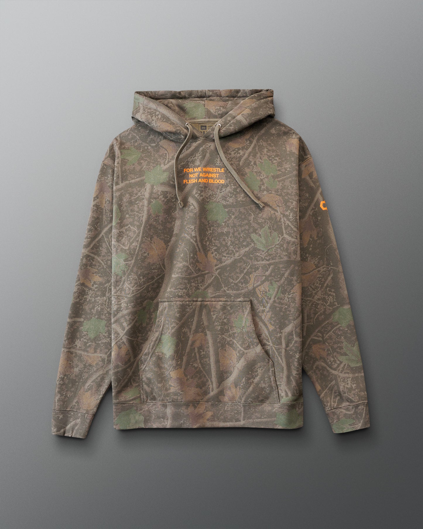 Camouflage hoodie with orange 'For we wrestle not against flesh and blood' text on a gray background