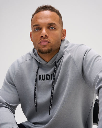 Model wearing the heather gray RUDIS Contrast COOL-FEEL Hoodie, highlighting the RUDIS chest graphic, branded drawcords, and raglan seams.