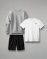 Gray sweatshirt, white t-shirt, and black shorts on a gray background