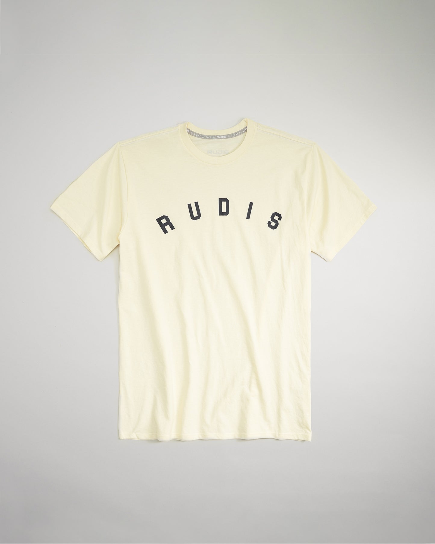 A light yellow t-shirt featuring a bold black lettered RUDIS print across the chest designed for comfort and casual wear