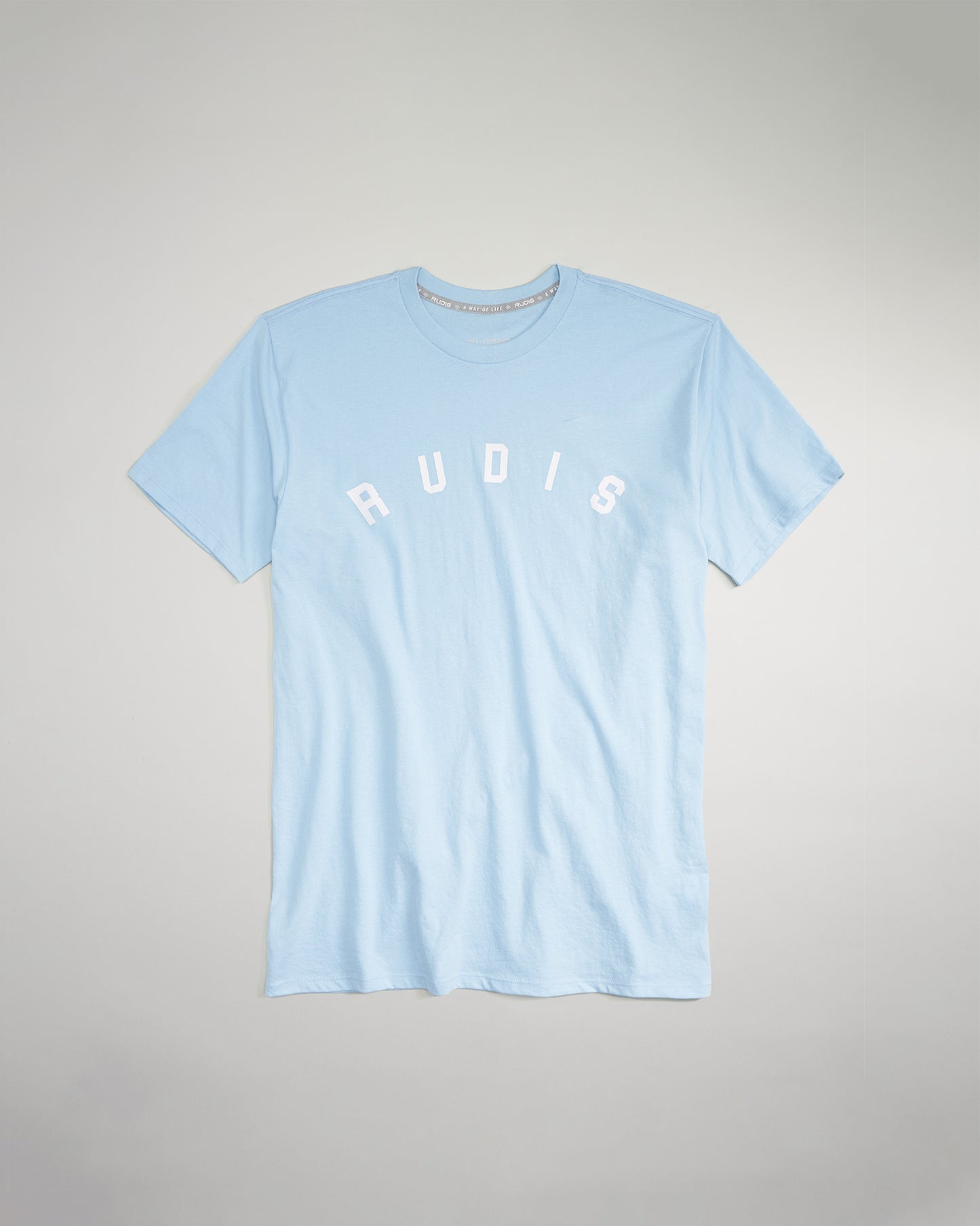 A light blue t-shirt featuring the word RUDIS prominently displayed in white letters across the chest