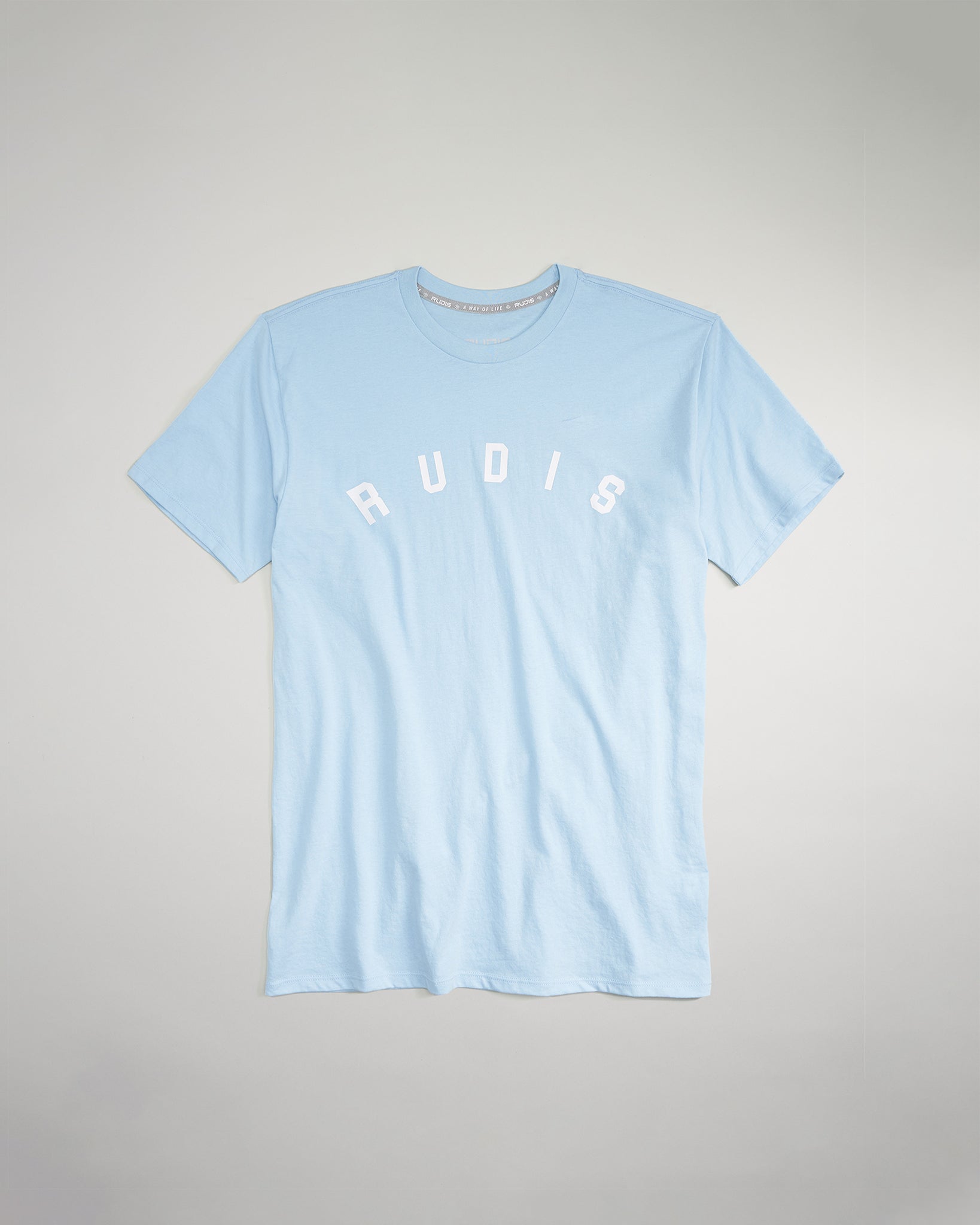 A light blue t-shirt featuring the word RUDIS prominently displayed in white letters across the chest