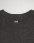 This image showcases the back neckline of a dark gray t-shirt featuring a subtle white logo design