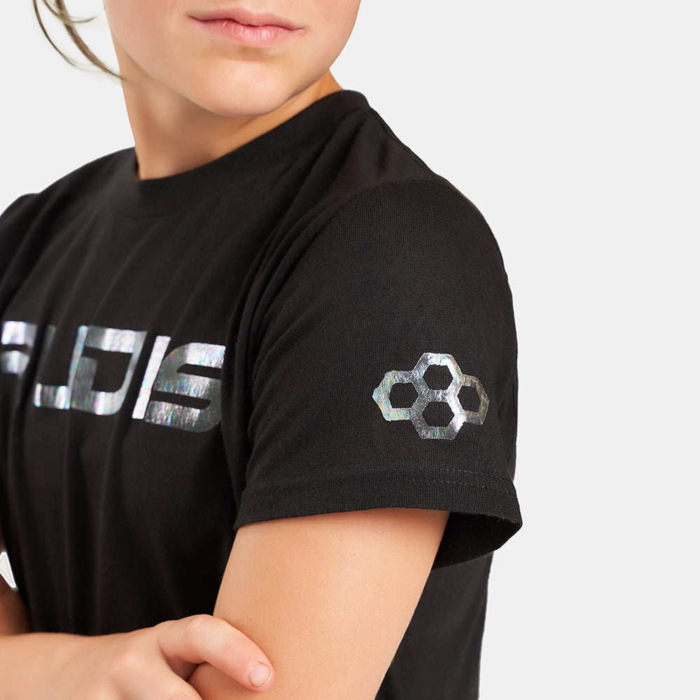 A close-up view of a child wearing a black t-shirt featuring a reflective logo and playful branding exuding a modern and sporty vibe