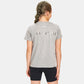 A young girl wearing a gray t-shirt with WAY OF LIFE printed on the back styled with black shorts showcasing an active lifestyle