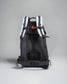 A sleek backpack featuring a dark design with white accents and ergonomic back support suitable for hiking or daily use