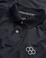 A close-up view of a black polo shirt featuring a classic collar two buttons and a geometric logo in a contrasting shade