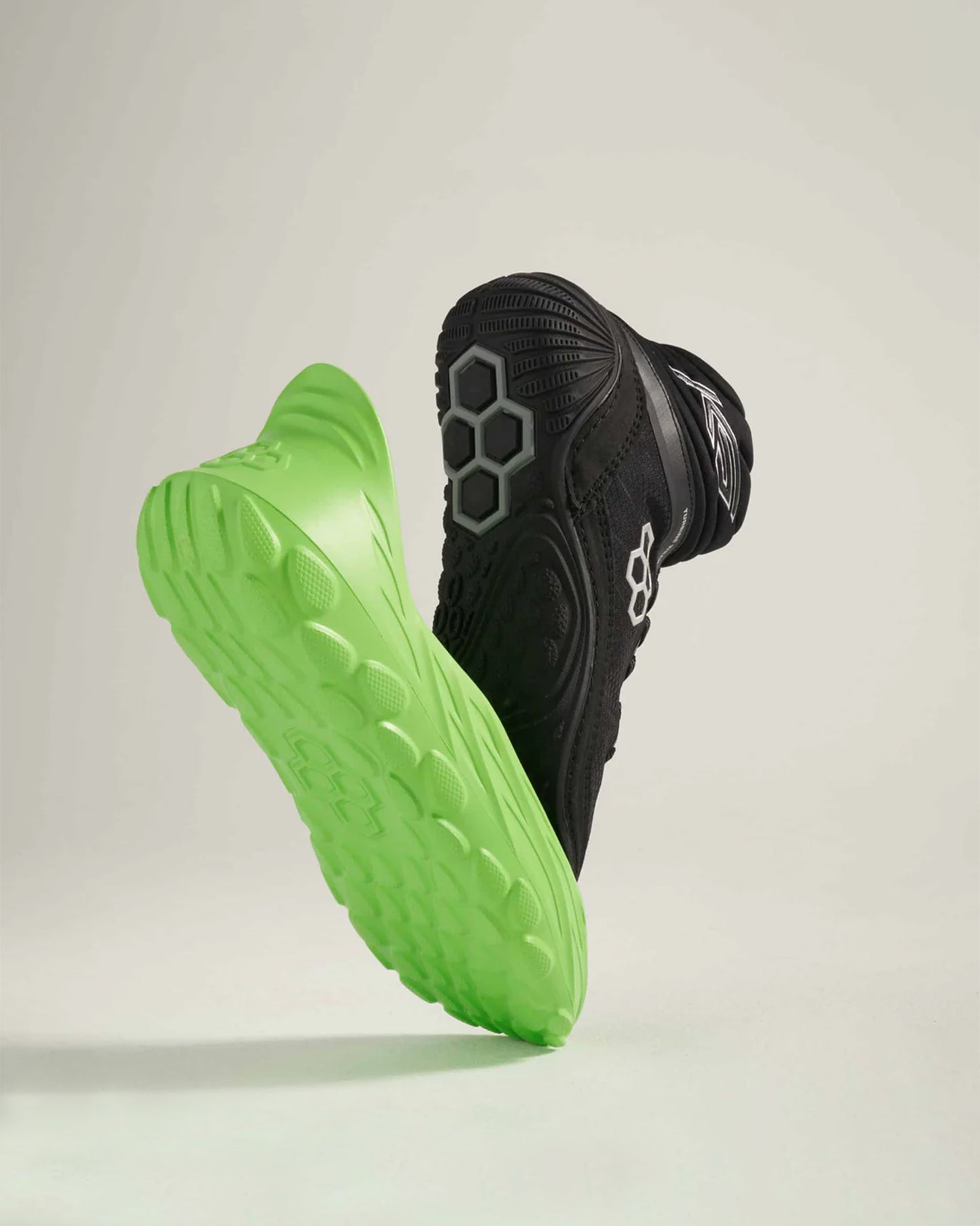 A dynamic pair of modern running shoes featuring a black upper and a bright green sole emphasizing their sleek design and performance-oriented features