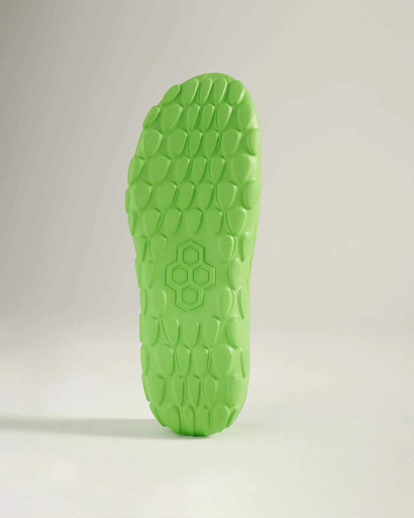 A vibrant green shoe sole featuring a textured design that enhances grip and traction
