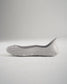 A side view of a minimalist gray slip-on shoe with a sleek design and textured sole perfect for casual wear