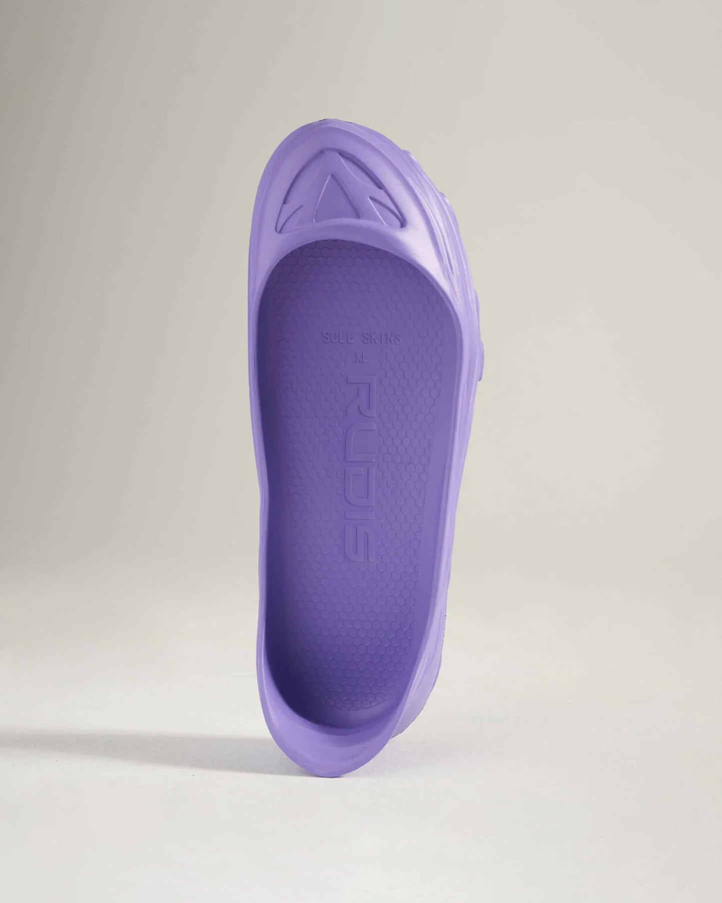 A stylish purple slip-on shoe featuring a sleek design and textured sole perfect for casual wear or outdoor activities