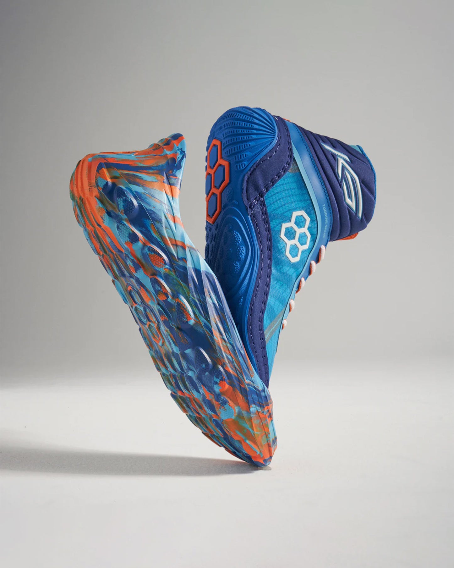 This image displays a pair of vibrant athletic shoes featuring a blue and orange color scheme emphasizing modern design and performance technology