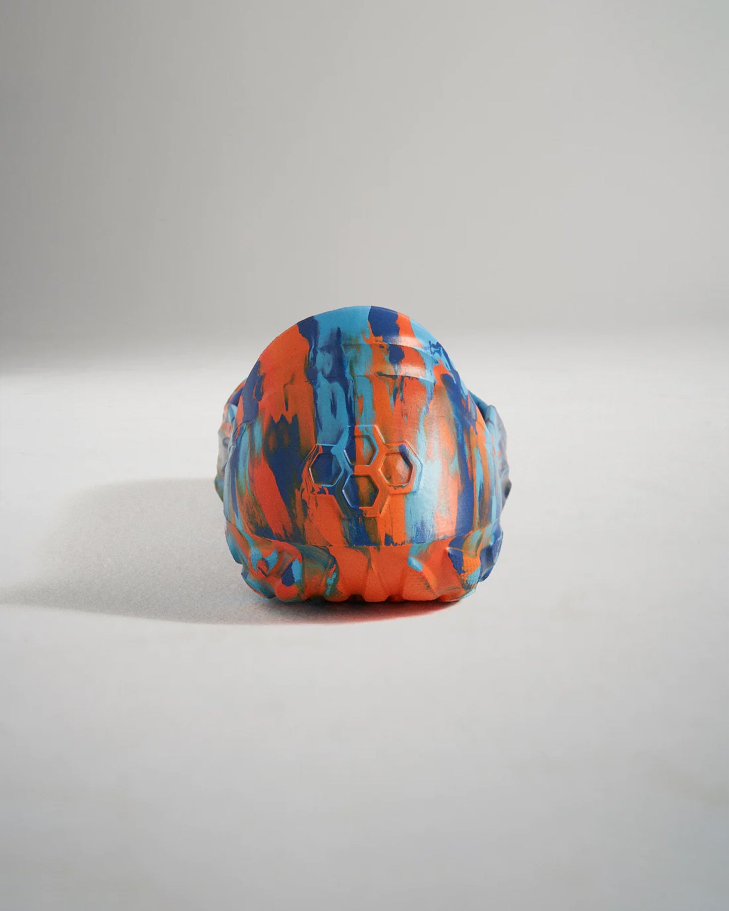 A vibrant and textured rubber toy in orange blue and teal colors designed for durability and playfulness