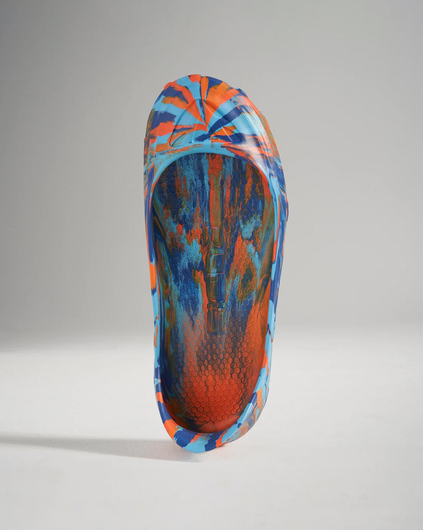 A vibrant and colorful athletic shoe showcasing a unique tie-dye design with blue and orange hues emphasizing its modern style and performance features