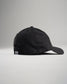 A black baseball cap viewed from the side featuring a curved visor and a signature tag on the back