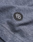 Close-up of a dark gray fabric featuring a round black patch with a geometric honeycomb design in white