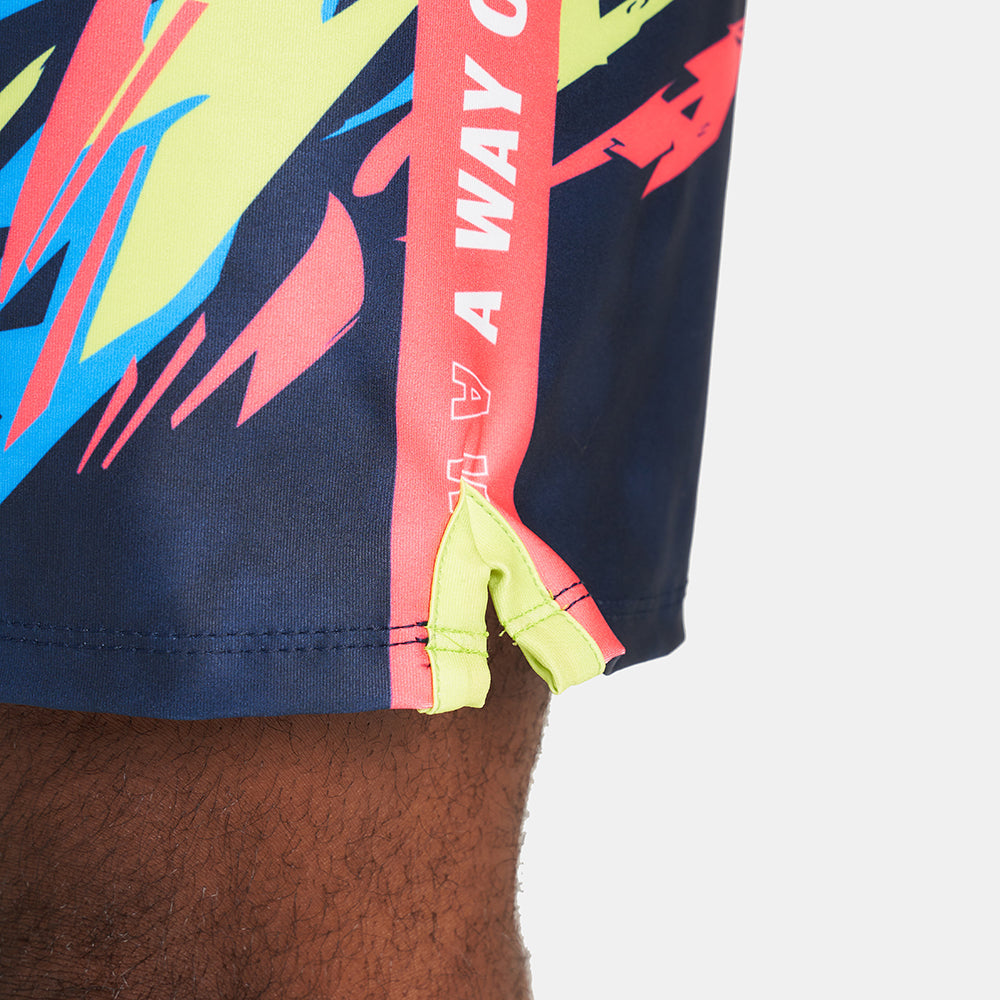 Vibrant swim shorts featuring a dynamic abstract pattern with blue yellow and pink colors alongside a bold logo on the side seam