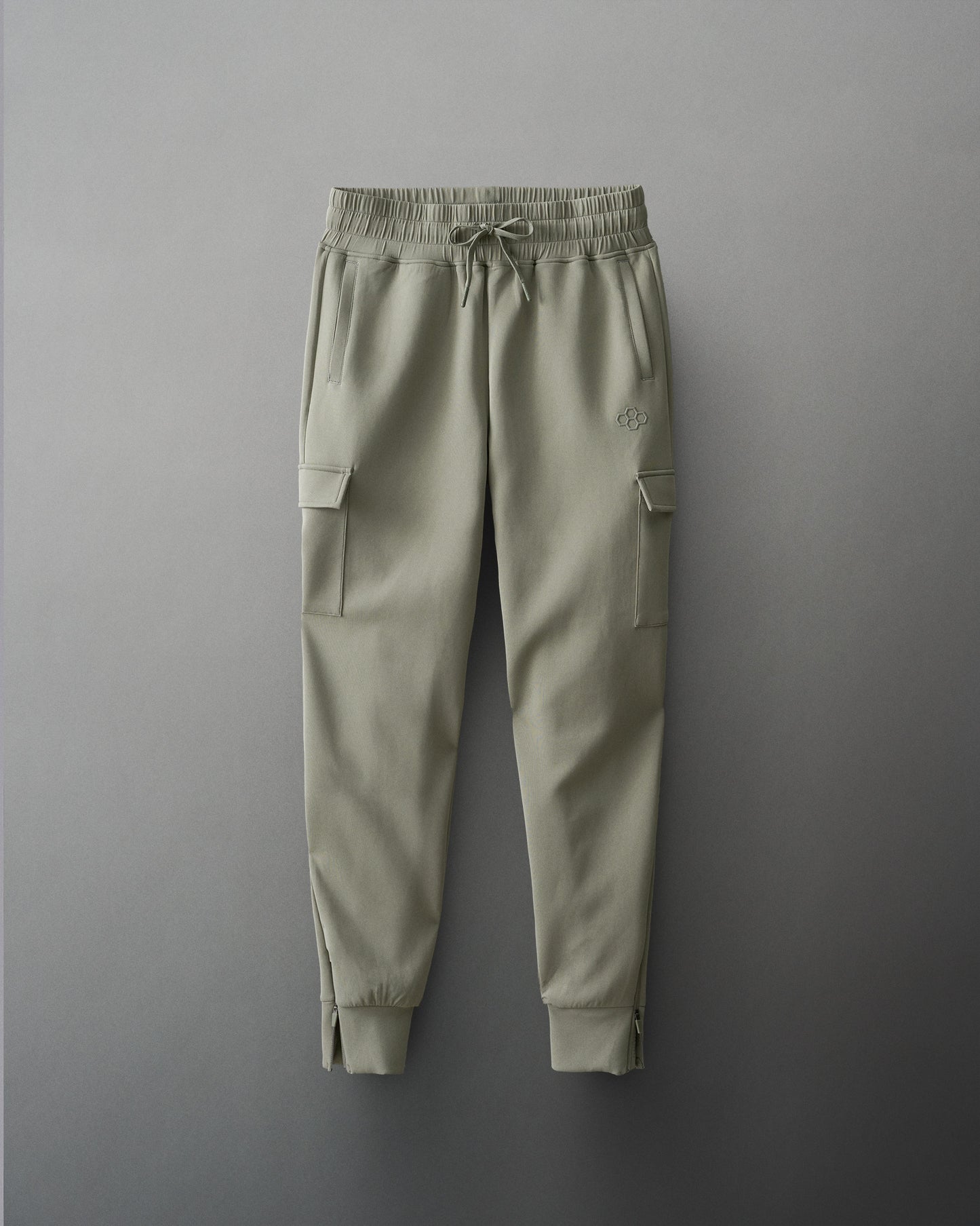 Green cargo jogger pants on a gray background