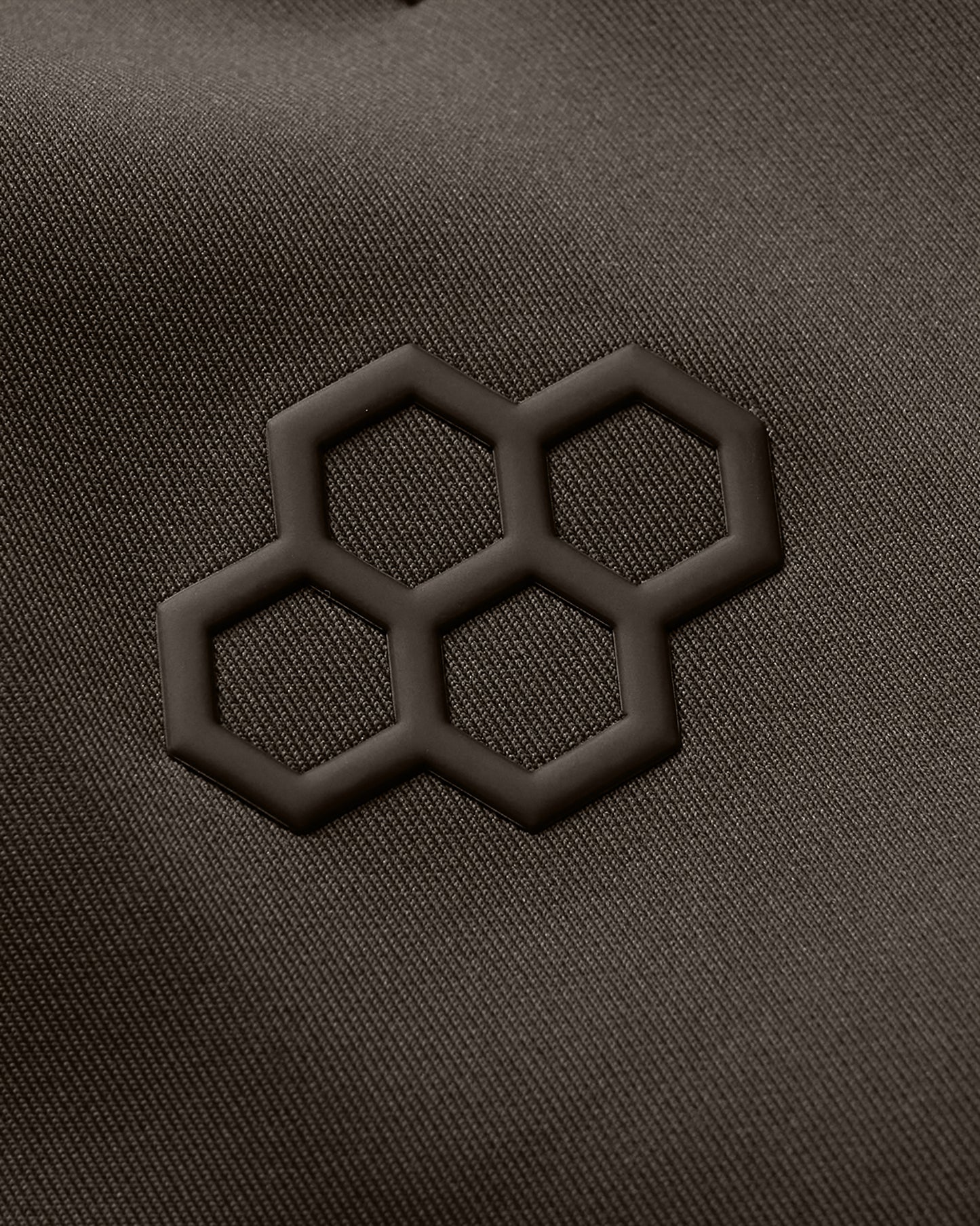 Close-up of a textured surface with a black geometric pattern on a dark gray background