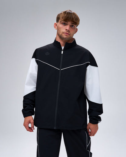 Model wearing the black RUDIS Full-Zip Movement Podium Jacket with white color-block sleeves and contrast piping.